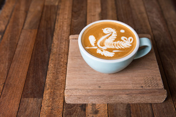 Latte art coffee cup  on wooden table