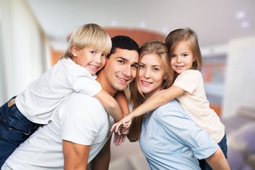 Beautiful smiling family sitting at sofa