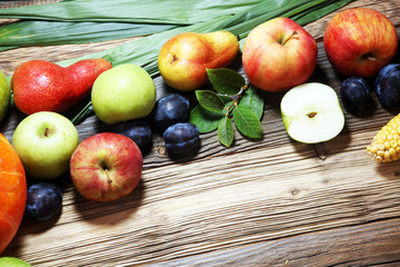 Various fresh fruits. Thanksgiving pumpkin, apples, and maize on rustic background.