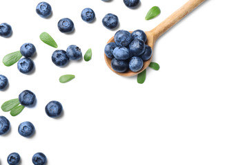Wooden spoon with ripe blueberries on white background