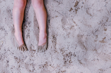 Closeup of feet of child at beach