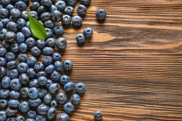 Ripe blueberries on wooden background