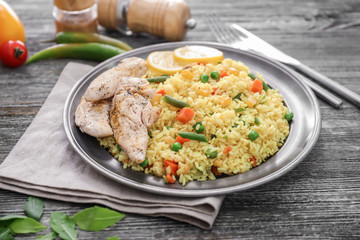 Tasty boiled rice with meat and vegetables on plate