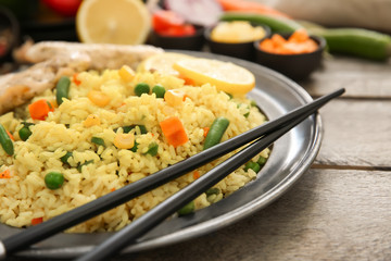 Tasty boiled rice with vegetables on plate