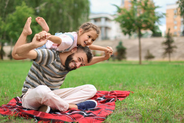 Little girl and her father playing outdoors