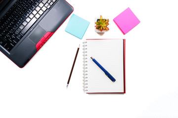 Top view or Flat lay style with copy space of workspace with laptop , pen , notebook , sticky note , pencil on white table background or isolated