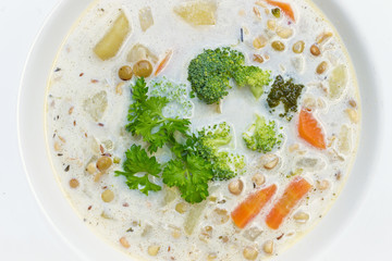 White Vegetable Soup with Broccoli, Carrot and  Lentils. Top View Food Detail on Plate. Czech Republic Cuisine.