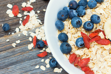 Healthy Breakfast with Goji, Blueberries and Oat Flakes in Bowl