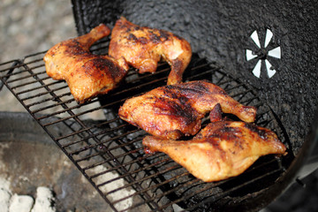 Grilled quarter chicken thighs and legs on the BBQ.