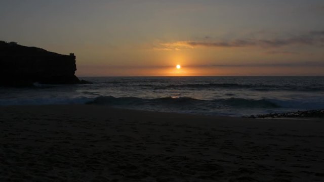 Sunset in Coxos beach in Ericeira village, Portugal.