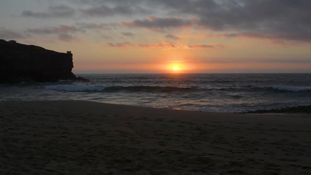 Sunset in Coxos beach in Ericeira village, Portugal.