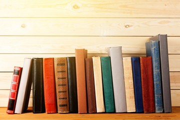 Ancient books in a row on wooden