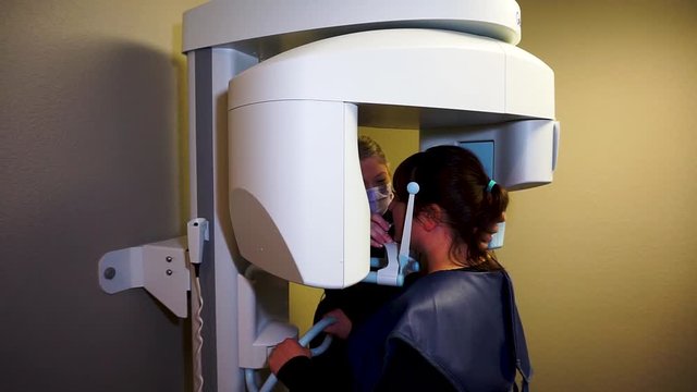Female patient taking panoramic x-ray with female assistant