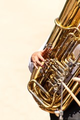 Closeup of tuba player in the street.  Presentation of the brass band. The instrument of the brass band tuba.