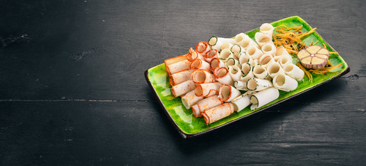 A set of lard with garlic, pepper and paprika. Ukrainian cuisine. On a wooden table. Top view. Copy space.