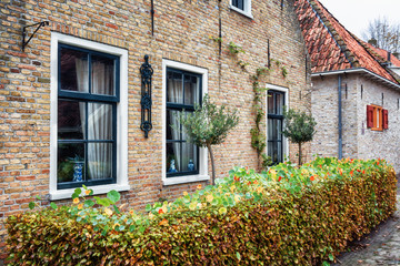 Fototapeta na wymiar The side wall with window of a house in Bourtange, a Dutch fortified village in the province of Groningen