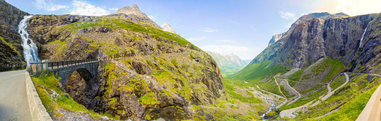 Panorama of Stigfossen waterfall under bridge and Trollstigen road in Norway