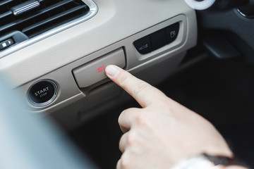 Hand pulling and pushing electric handbrake, Modern car interior.