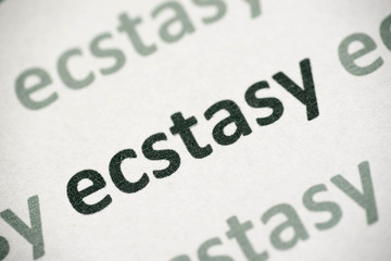 word ecstasy printed on paper macro