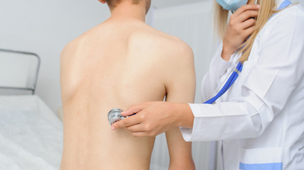 The doctor is consulting the patient with ultrascope at his back