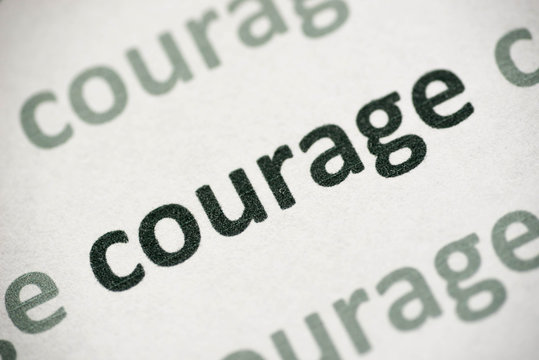 word courage printed on paper macro