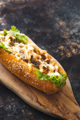 Long bread with mayonnaise on rustic background 