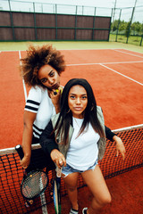 young pretty girlfriends hanging on tennis court, fashion stylis