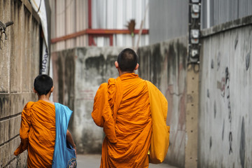 monks walking on the street