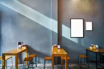 Coffee cafe and restaurant loft style with dark grey wall and brown wooden table set, white blank...