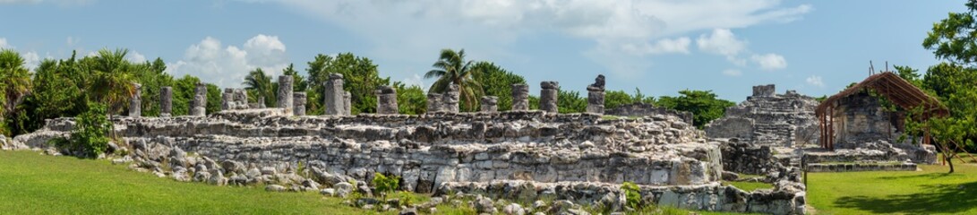 Fototapeta na wymiar Mayan ruins in Cancun. Small mayan town is now in ruins. Iguanas rule the place these days and are practically the most interesting thing to see
