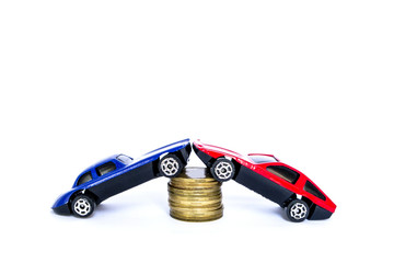 Isolated toy cars red and blue interact with gold coins.