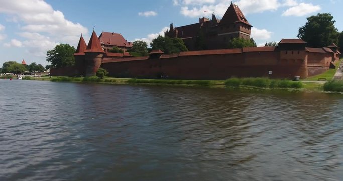 Flying Over River. View On Medieval Castle In Malbork