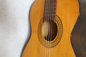 Orange guitar close-up with black ornament