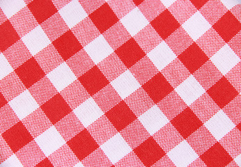 
Red tablecloth in a cage isolated on a white background