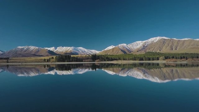 Lake tekapo new zealand with reflection of mouthains. Drone Footage