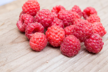 Raspberries on a wooden background. Selective focus.
