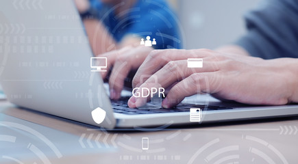 close up on programmer man hand typing on laptop with virtual  interface of GDPR ,  privacy personal data concept