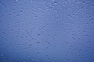 Blue water drops on the glass