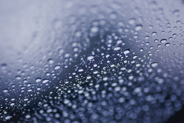 Blue water drops on the glass