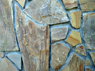 texture natural stone. rock. brown. sunny day.