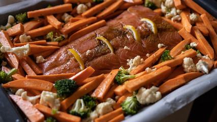 red fish salmon with sweet potatoes, broccoli and cauliflower for baking in the oven. healthy food