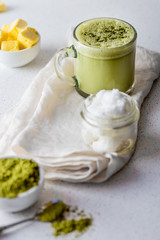 BULLETPROOF MATCHA. Ketogenic keto diet hot drink. Tea matcha blended with coconut oil and butter. Cup of bulletproof matcha and ingredients on white background