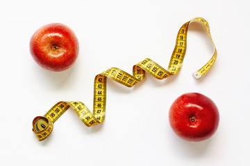 Measure tape and fresh fruits apples on white background. Loss weight, slim body, healthy diet concept