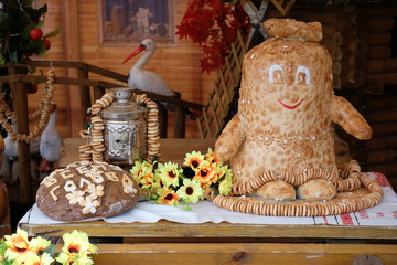 Baking at the autumn fair. Inscription on bread: «Bread is the staff of life».
