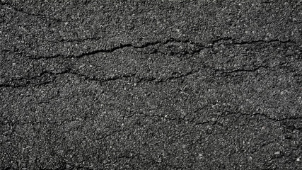 crack and texture of asphalt road - top view background.