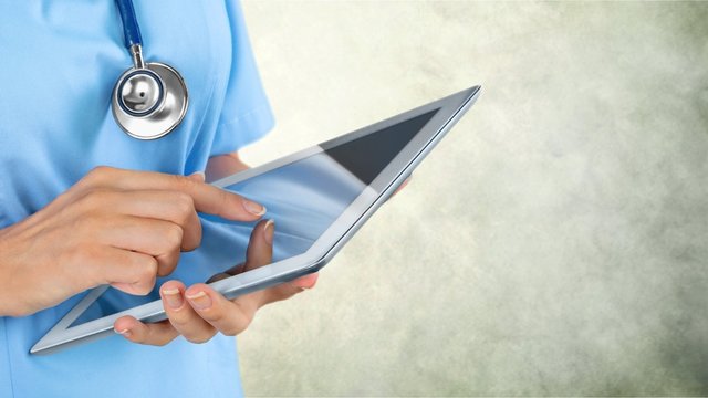 Close-up Doctor at hospital working with tablet