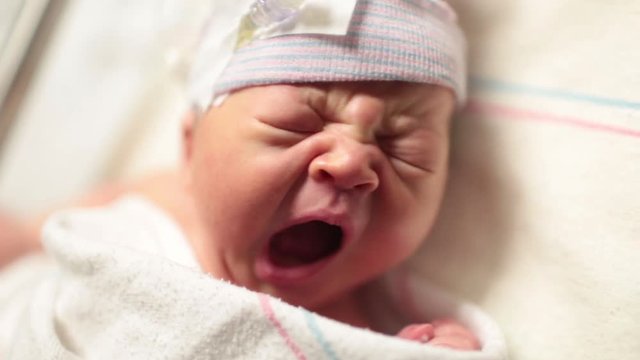Close Up Newborn Baby Yawning in Hospital