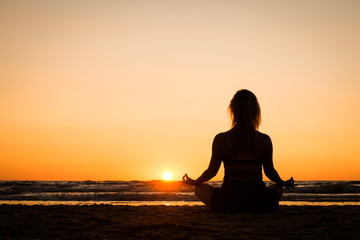 Silhouette of a girl practicing yoga