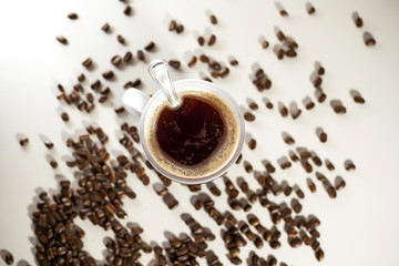 Isolated Coffee Cup with hot coffee and coffee beans