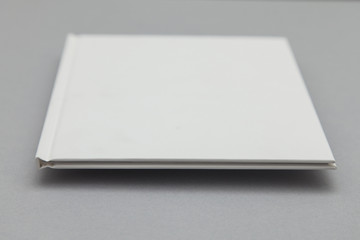 Hardback book cover mockup. White book on a grey background